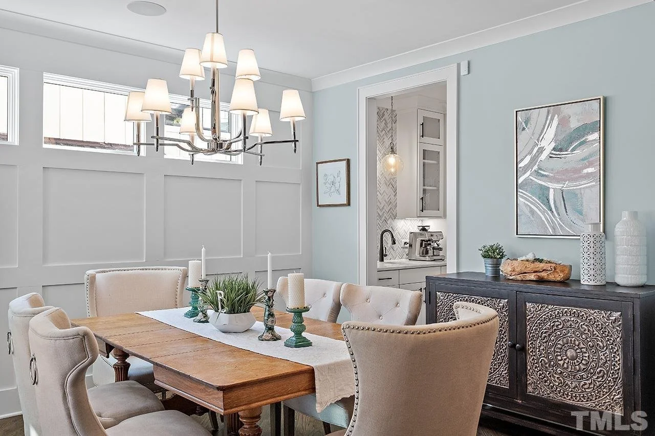 Staged dining room with wainscoting in a move-in-ready Triangle home