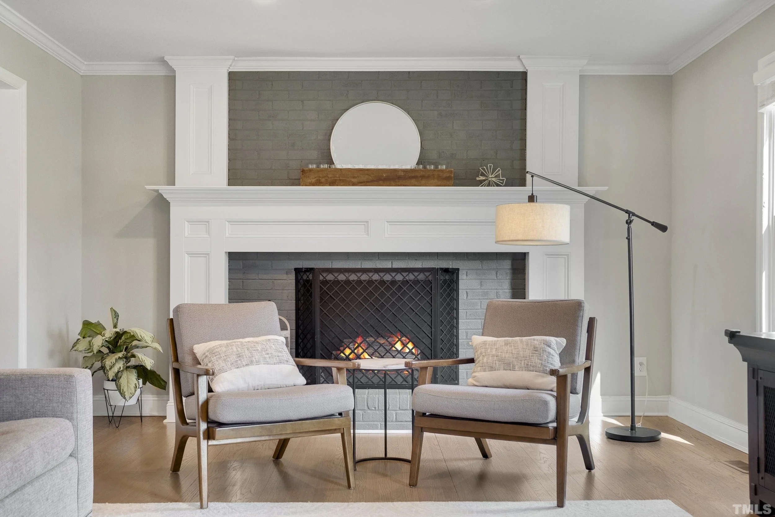 Staged living room with a fireplace mantel in a Raleigh home