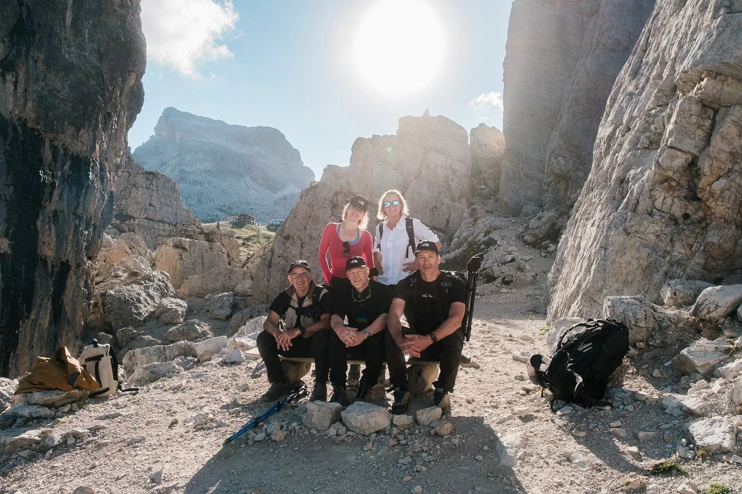 Workshop participants posing together between the towering rock walls at Cinque Torri.
