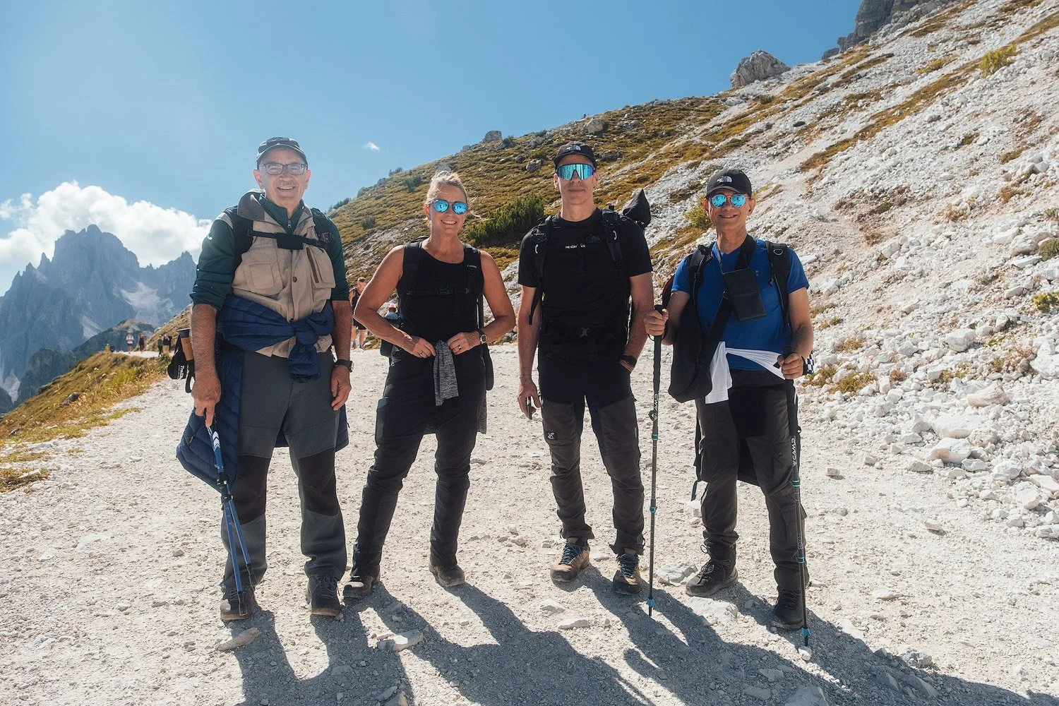Four workshop participants pausing on the rocky trail around Tre Cime di Lavaredo.