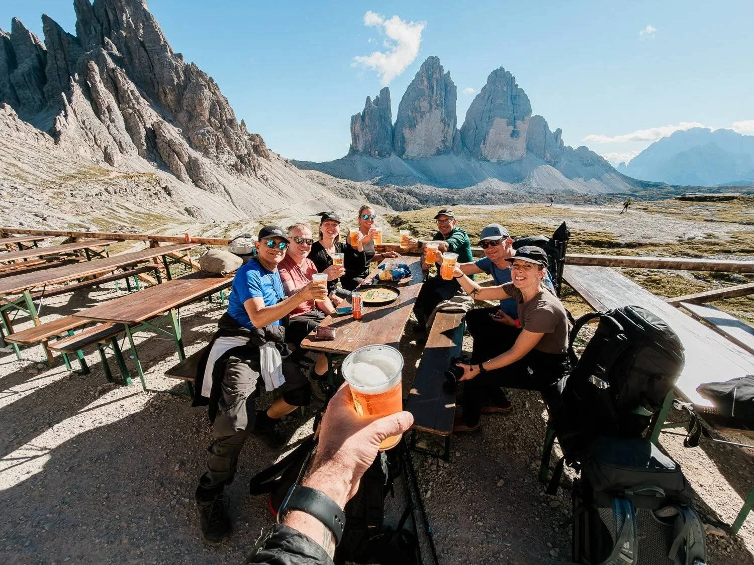 The workshop group sharing beers on Locatelli mountain hut terrace overlooking Tre Cime di Lavaredo.