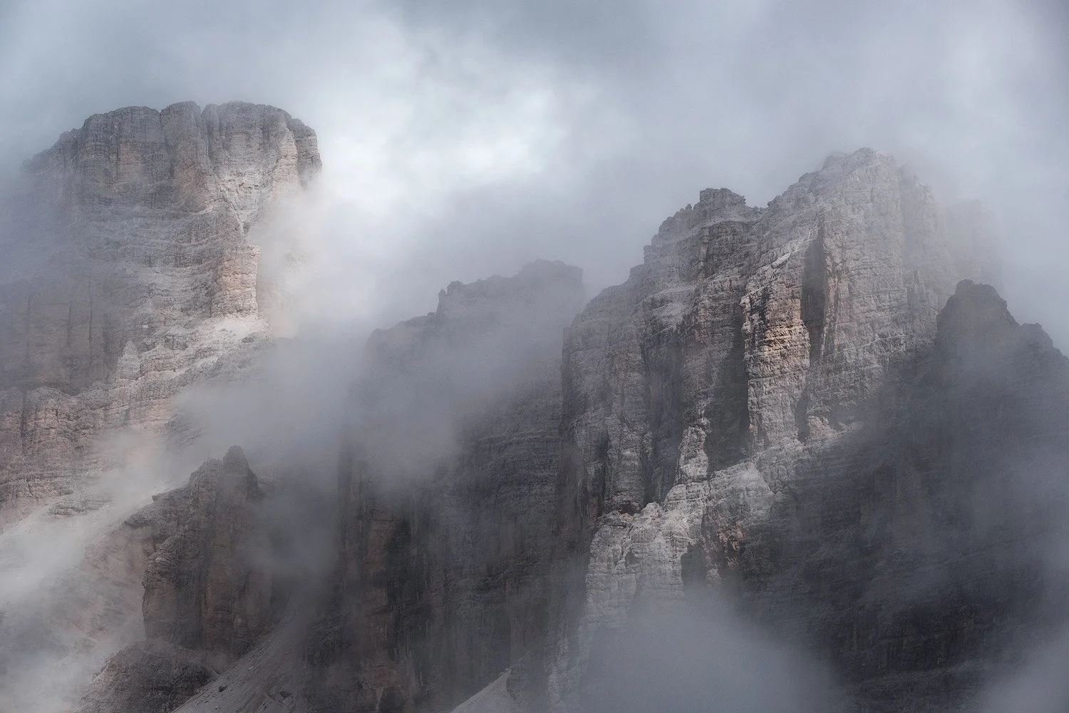 Clouds drifting between steep rock towers seen from Lagazuoi in the Dolomites.