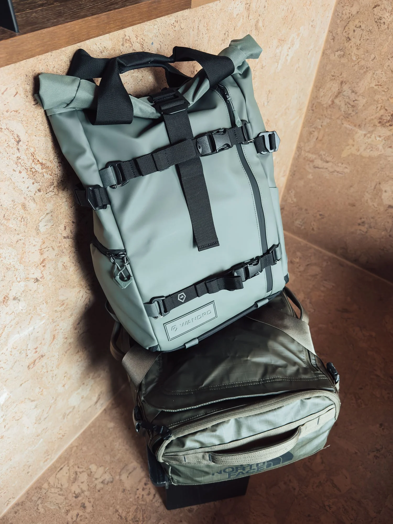 WANDRD PRVKE 21L Gen 4 backpack lying open to show its camera compartment and roll-top design.