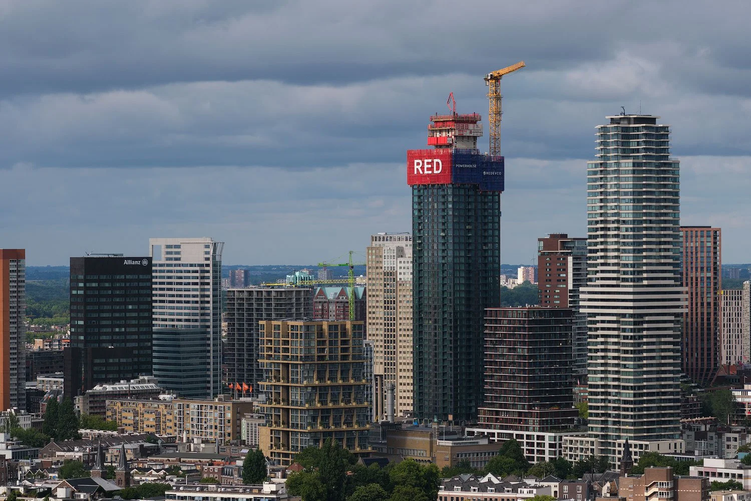 Wider 100mm view of the Rotterdam skyline containing the RED construction tower and neighbouring high-rises.