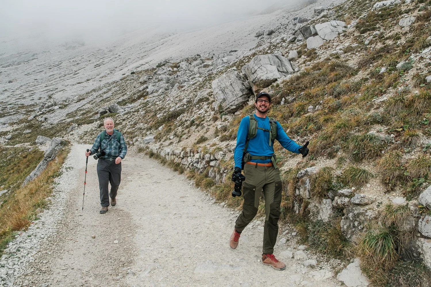 Dolomites Signature Workshop participants hiking toward Forcella Lavaredo through low cloud.
