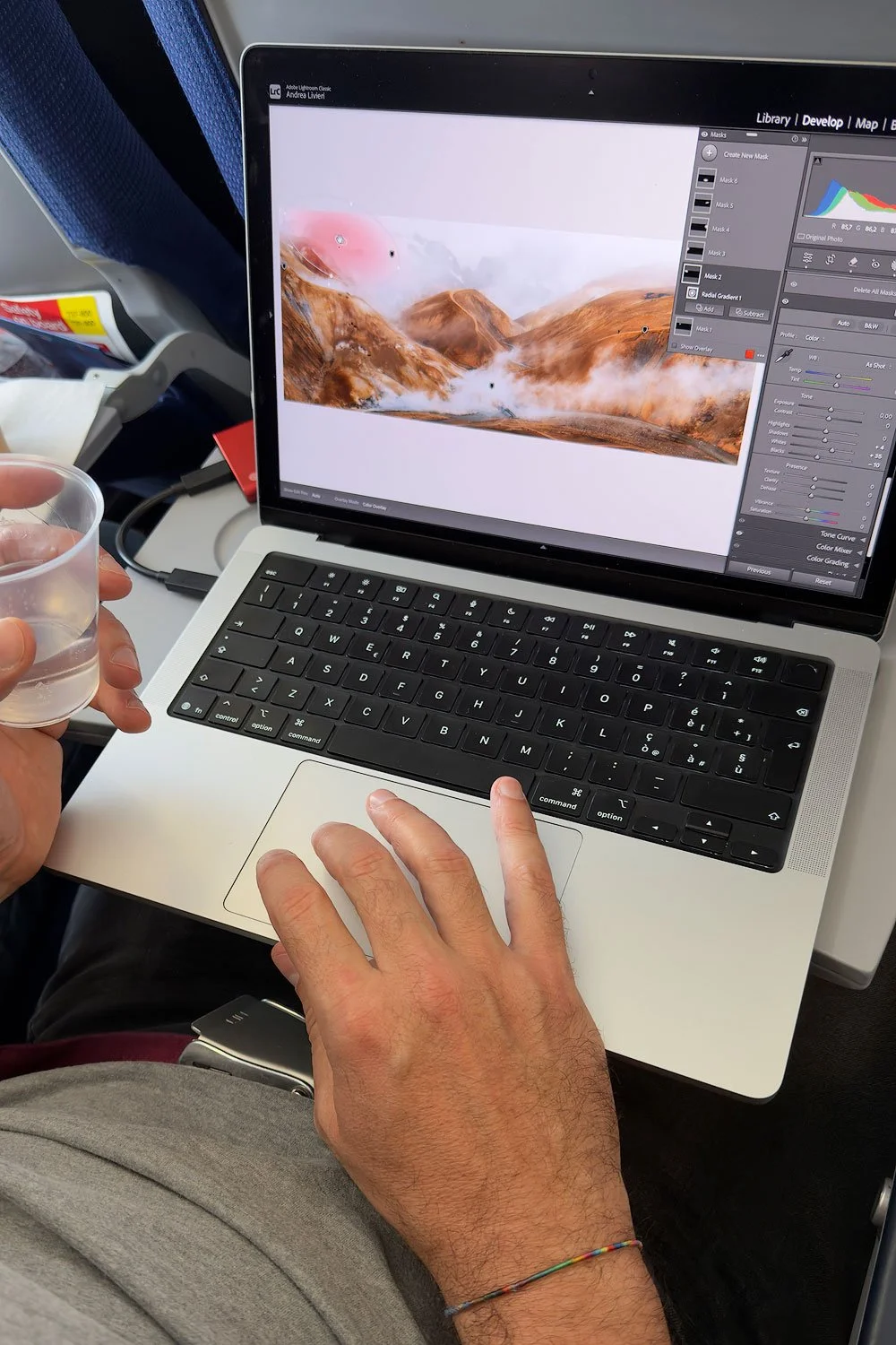 Andrea livieri editing in an airplane after the iceland workshop with his macbook pro m5 pro