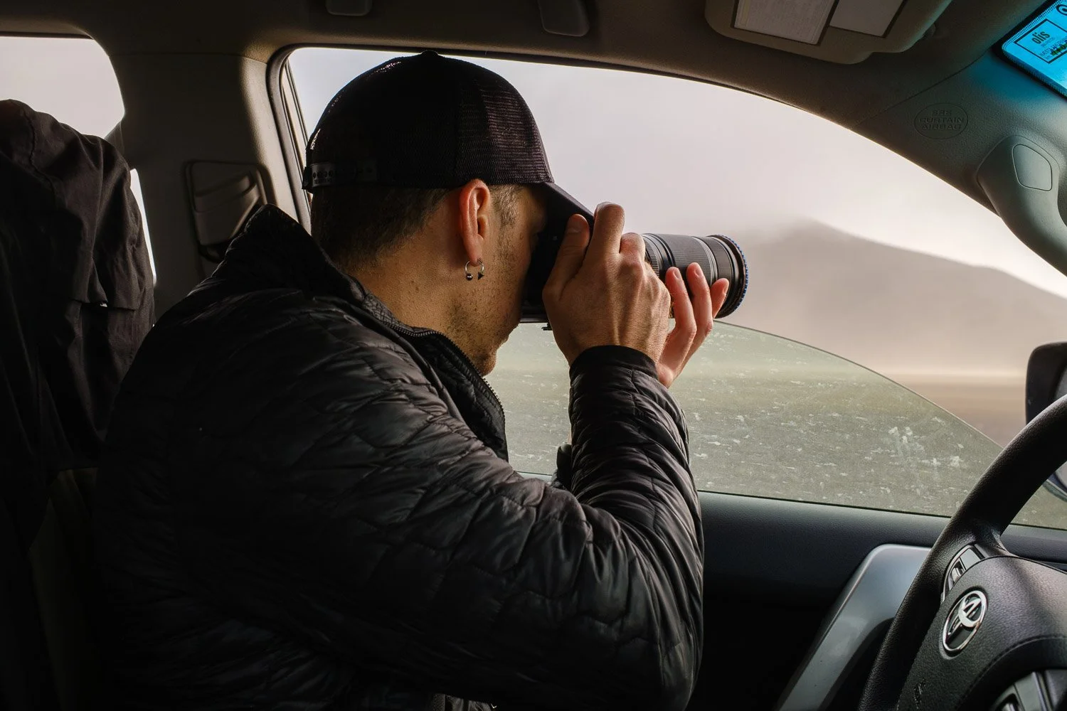 Andrea Livieri photographed in the 4x4 while photographing a sand storm in the iceland highlands