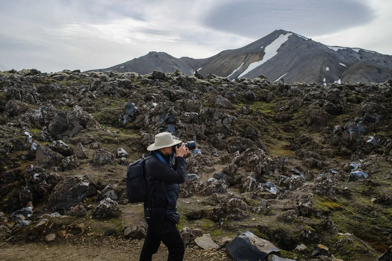 a workshop participant photographing in the lava fields of Landmannalaugar area