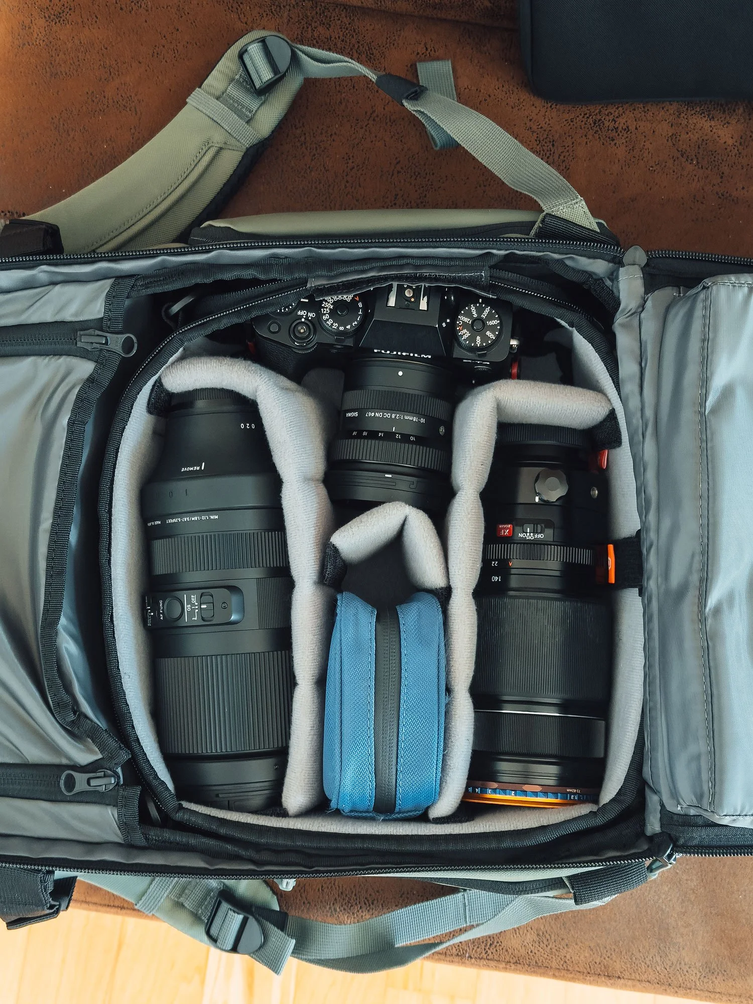 Open WANDRD PRVKE 21L backpack packed with a Fujifilm X-T4, Sigma 10–18mm, Fujinon 50–140mm and Sigma 100–400mm.