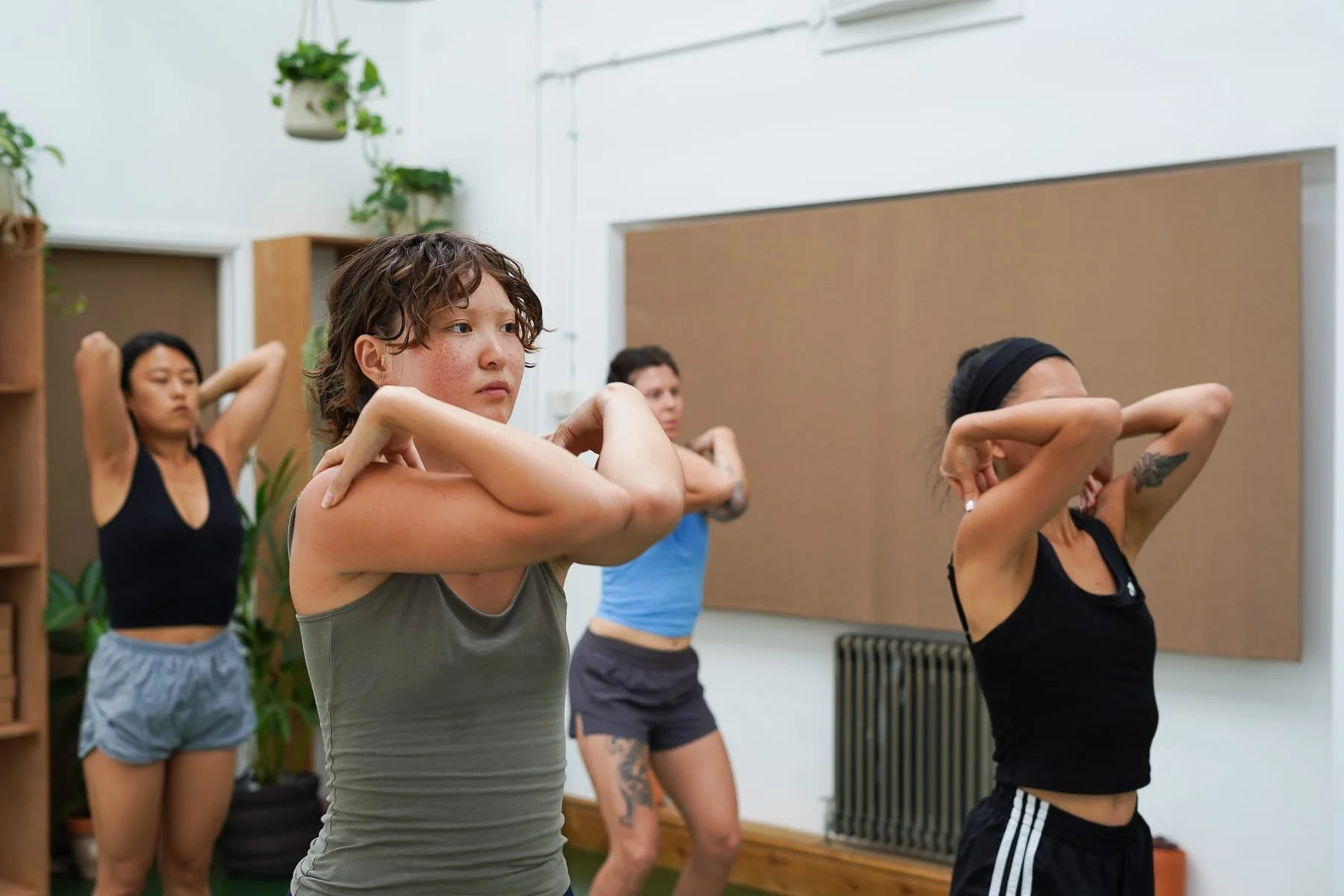 yoga attendees elbows touching class sunroom community sauna baths