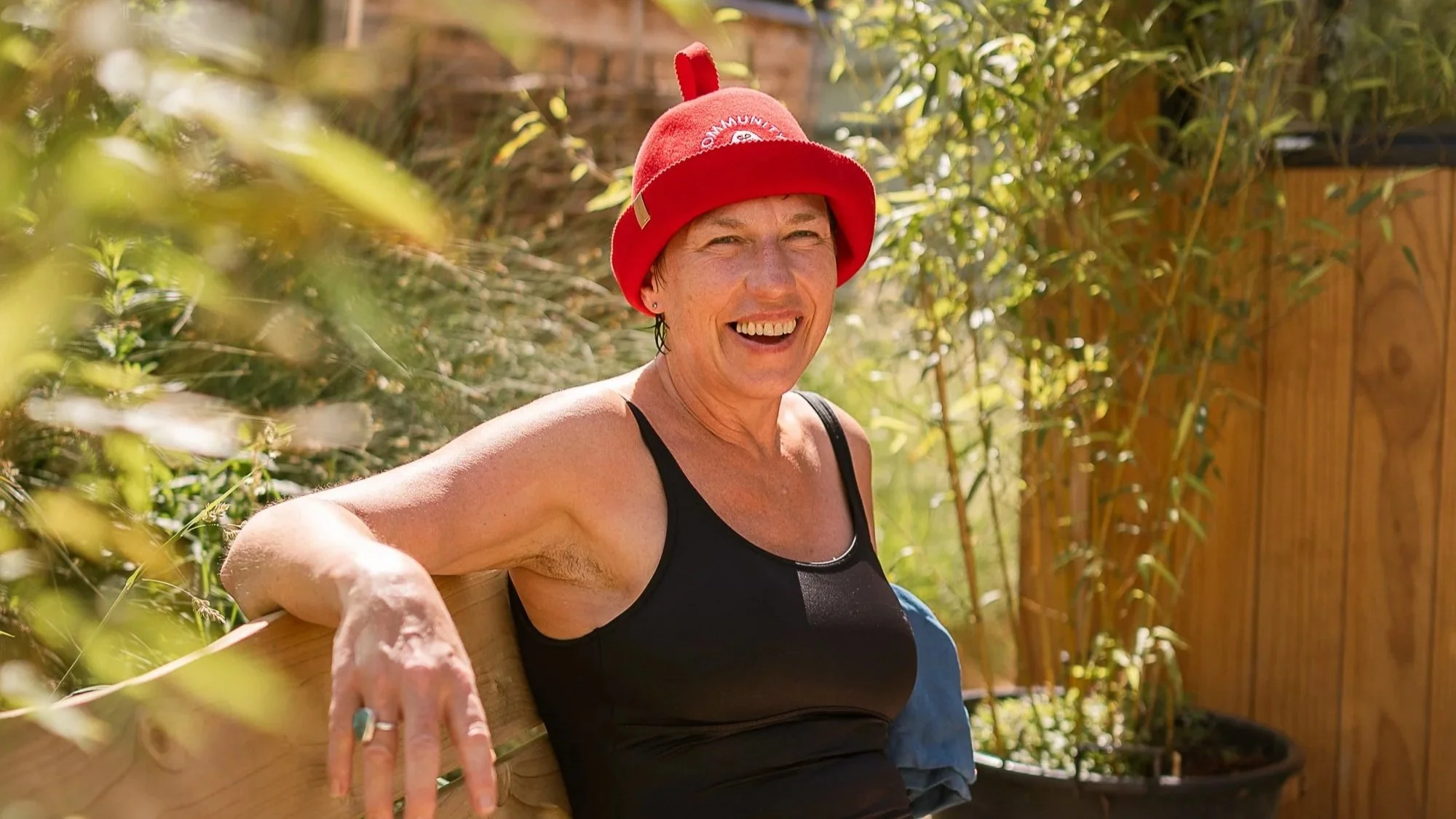 smiling sauna goer enjoying the sunshine at Stratford Community Sauna Baths London