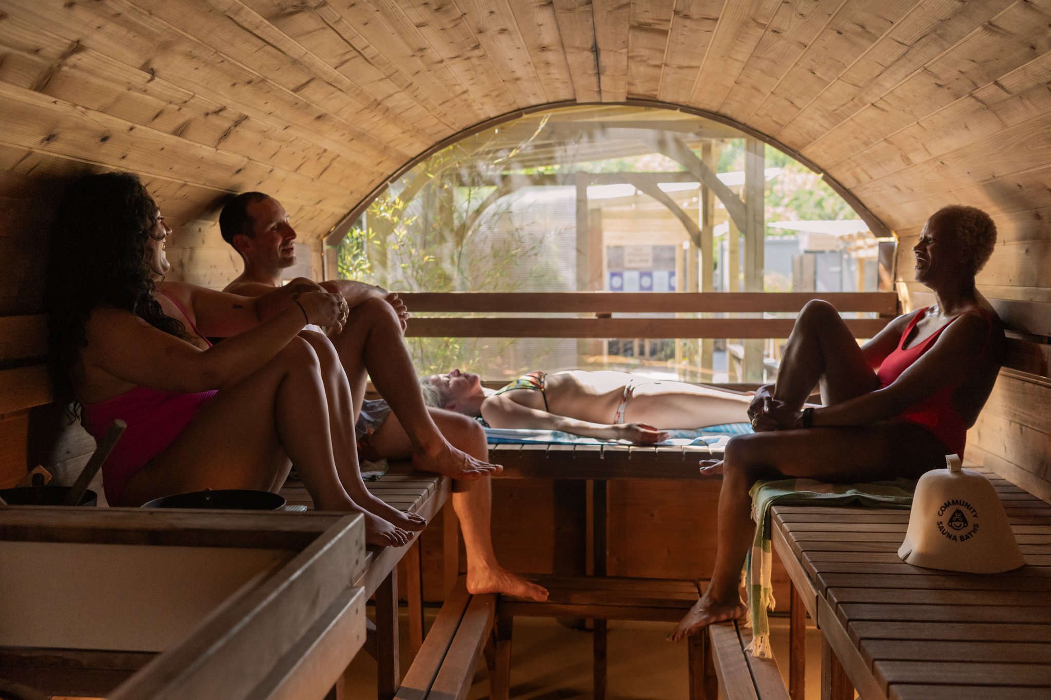sauna goers chatting in the sunny sauna at Camberwell Community Sauna Baths London