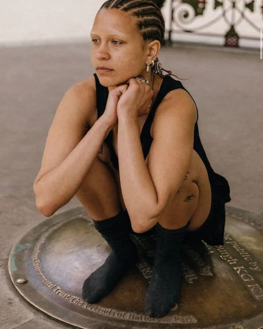 instructor claudia squatting looking into the distance