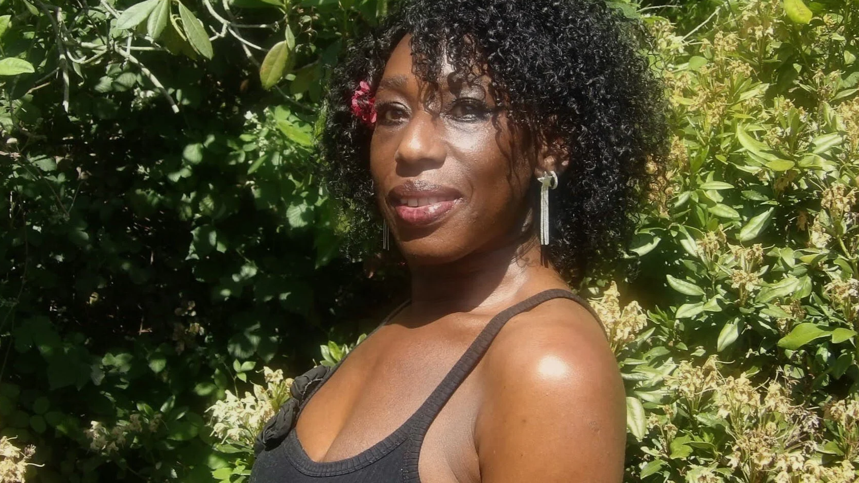 Energy practitioner Caroline smiling with a flower in her hair