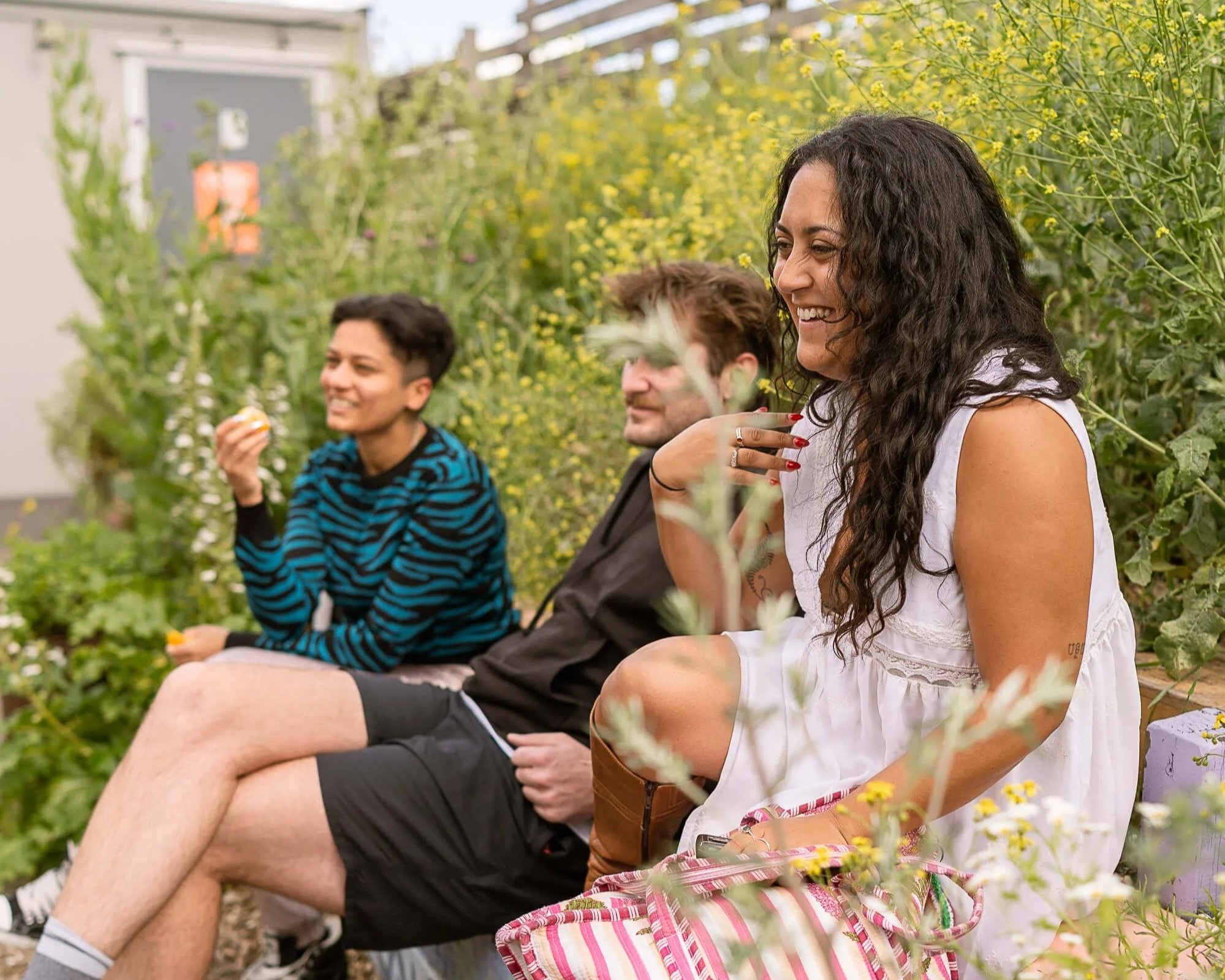 sauna bathers relaxing in the community garden after a session at Stratford Community Sauna Baths London