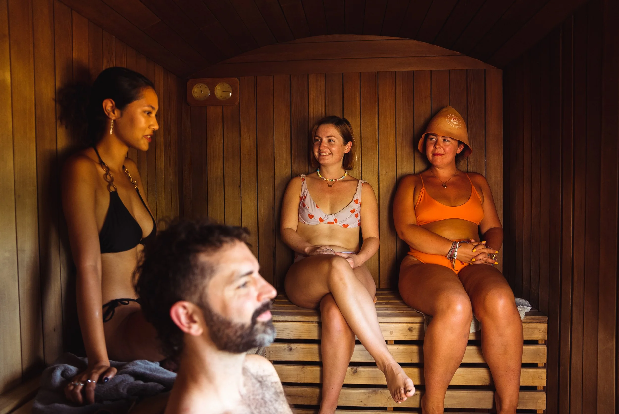 sauna bathers relaxing in the sauna on the benches at peckham community sauna baths london