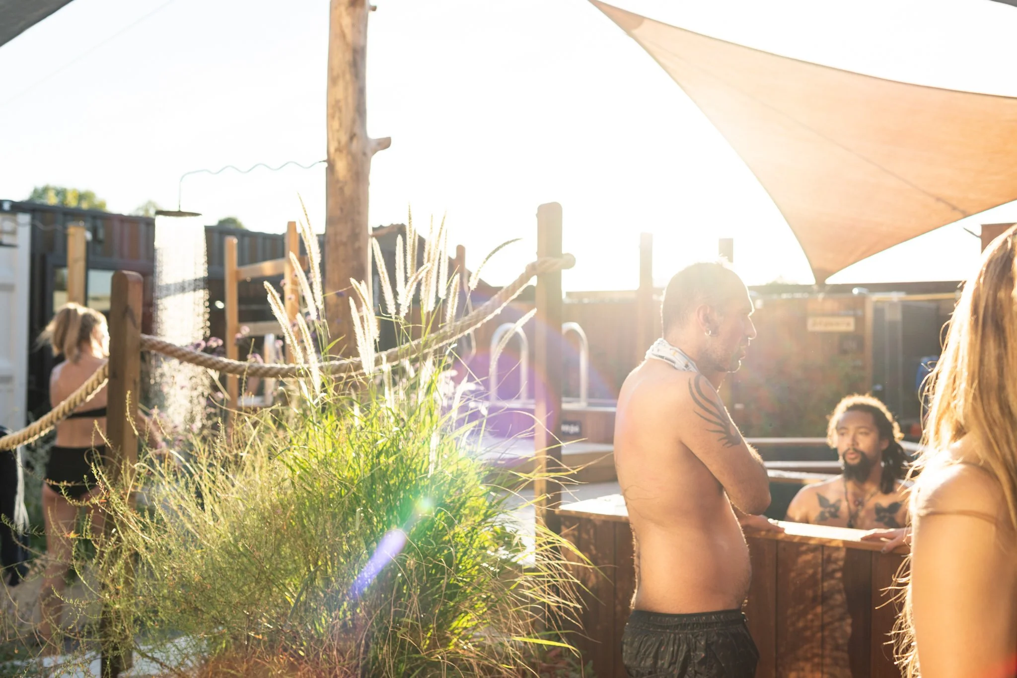 sauna bathers enjoying the sunshine and cold plunges at Walthamstow Community Sauna Baths London