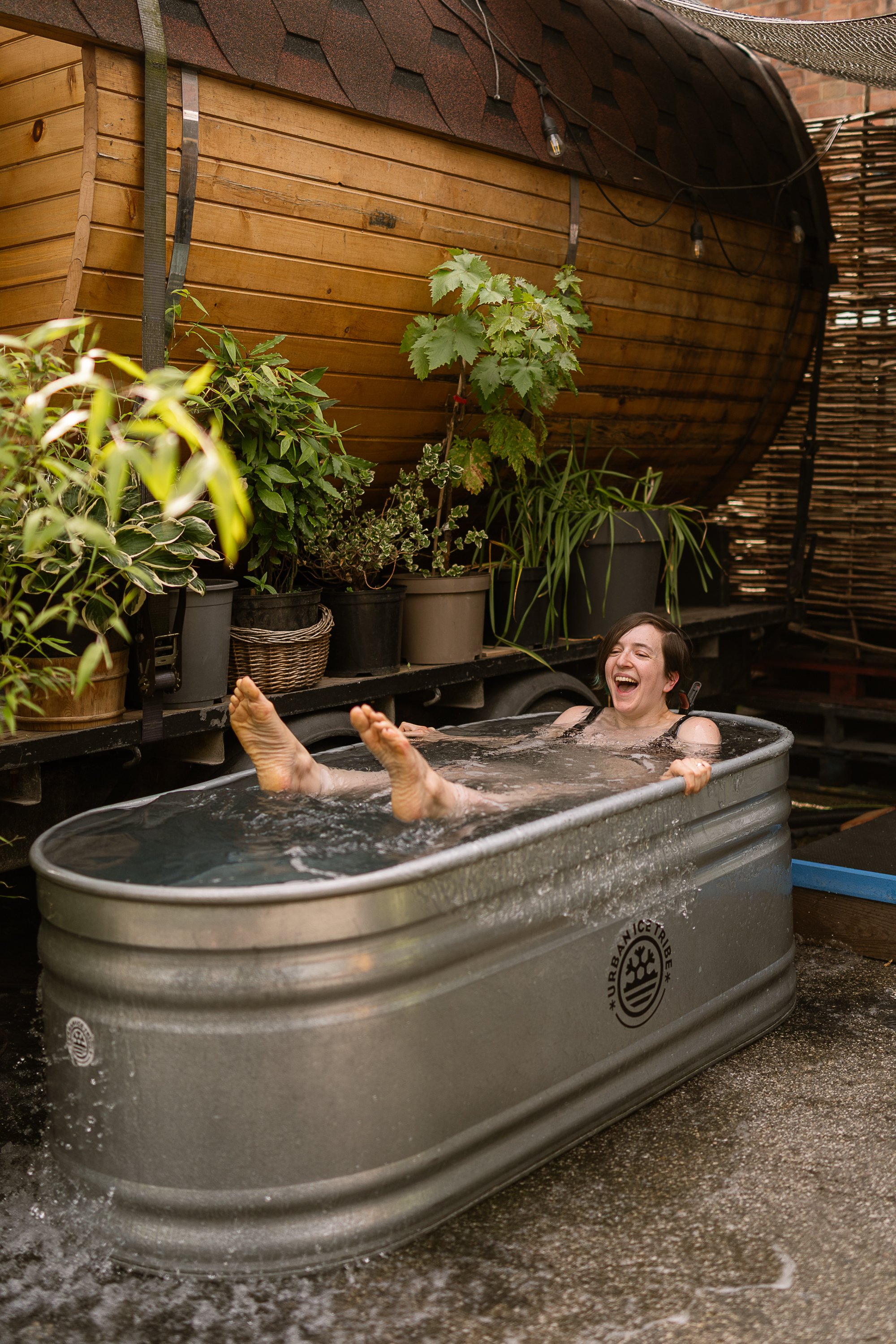 bather laughing and enjoying the cold plunge hackney wick community sauna baths london