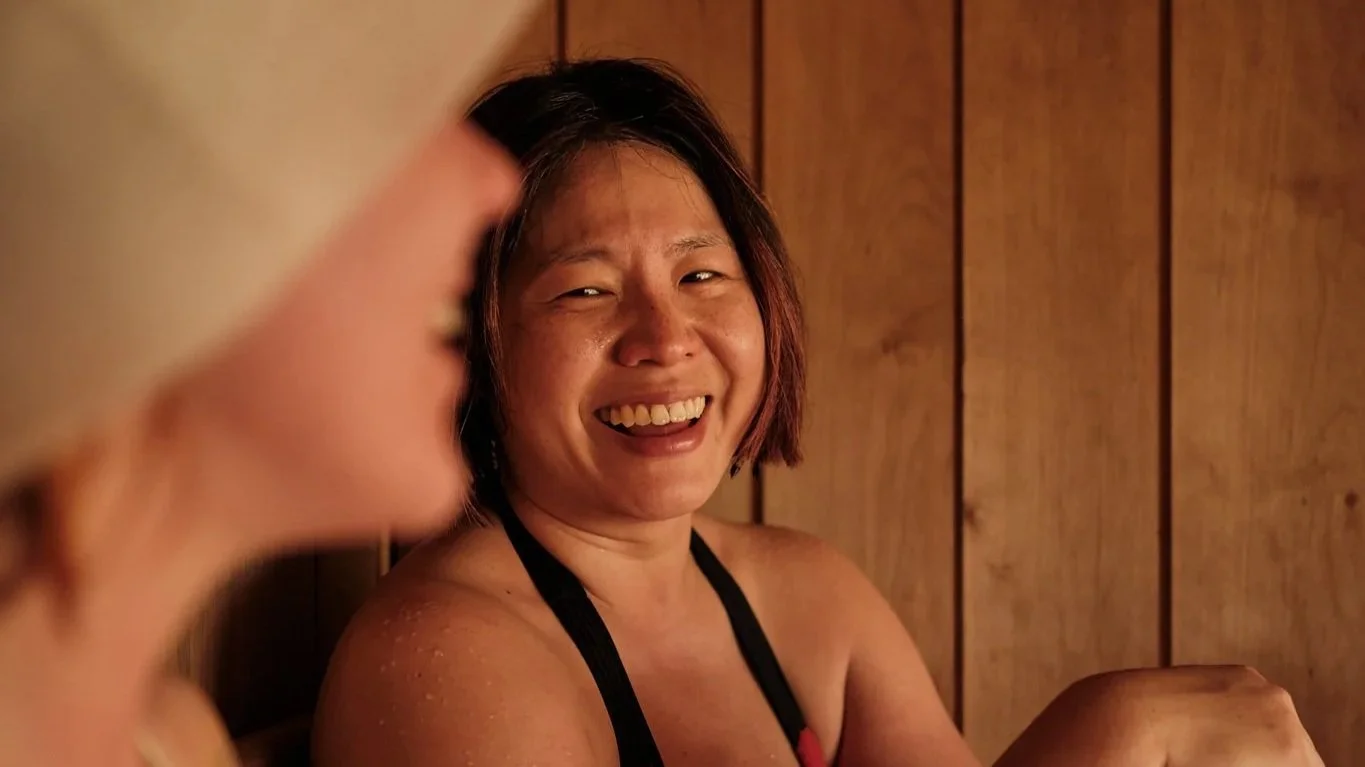 Lady smiling while in sauna at Community Sauna Baths Peckham London