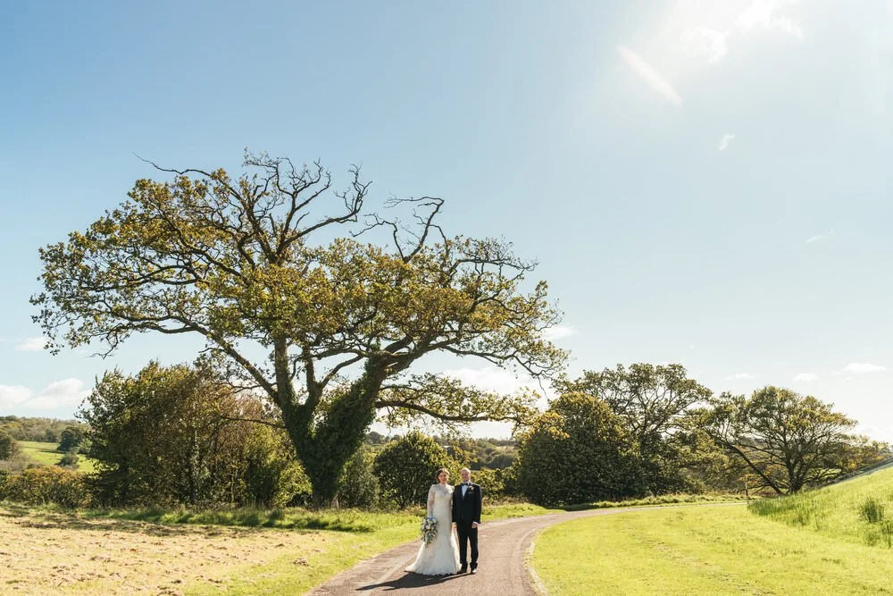 Wedding couple walking through Botanic garden on Wales