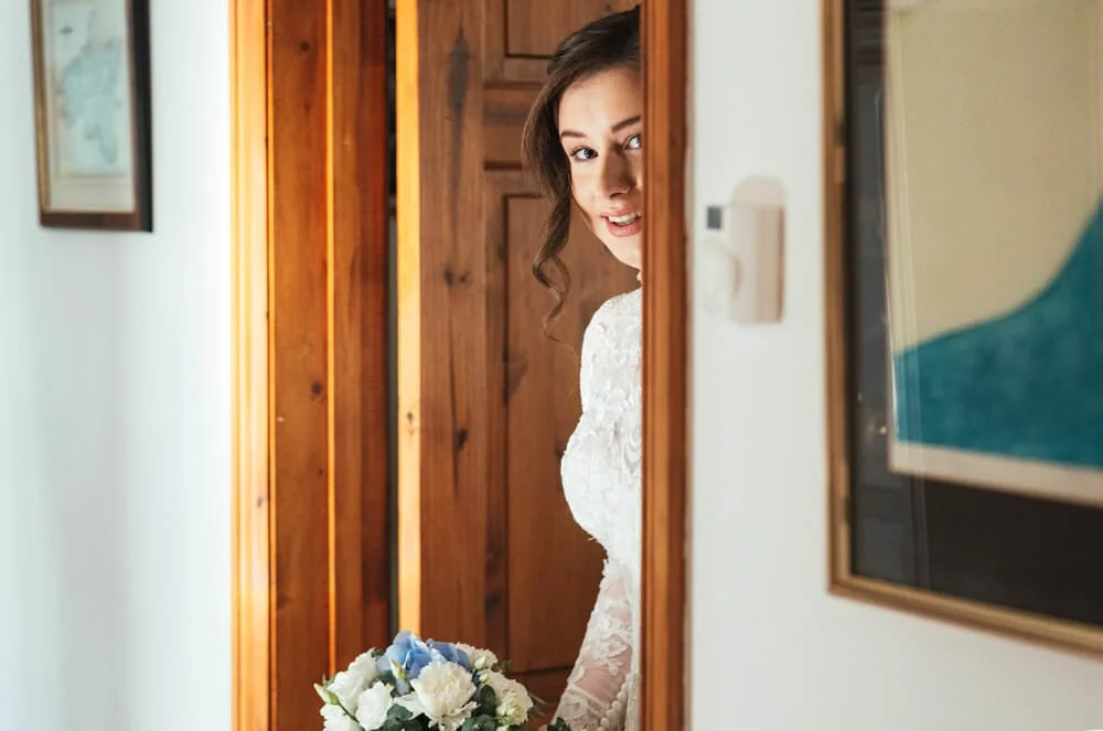 Bride peeping around door