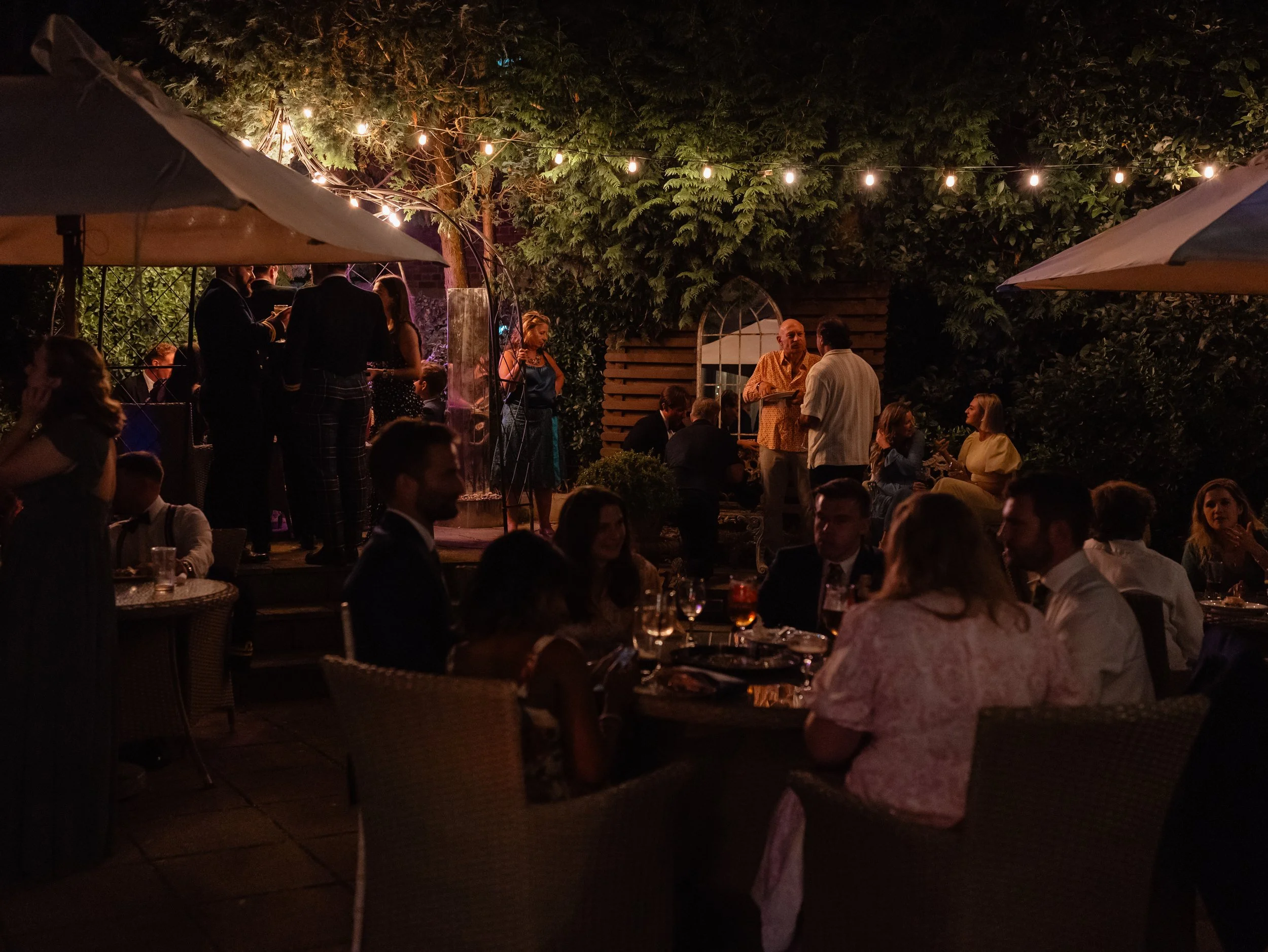 Wedding party scene outside the Bear hotel in Cowbridge, lit with festoon lighting and a relaxed wedding atmosphere.