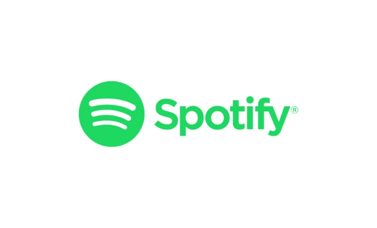 Spotify logo with green circle and three curved lines, followed by the word 'Spotify' in green text.