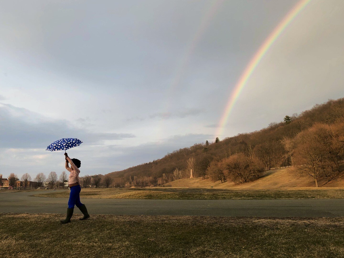 Here is the photo included in the online exhibition Focus/Capture/Inspire with the Edward E. Dixon Gallery. It is titled Rainbows. It is a double rainbow taken of my daughter Serena at the nearby Knickerbacker Park. 

We tightly hold our umbrellas an