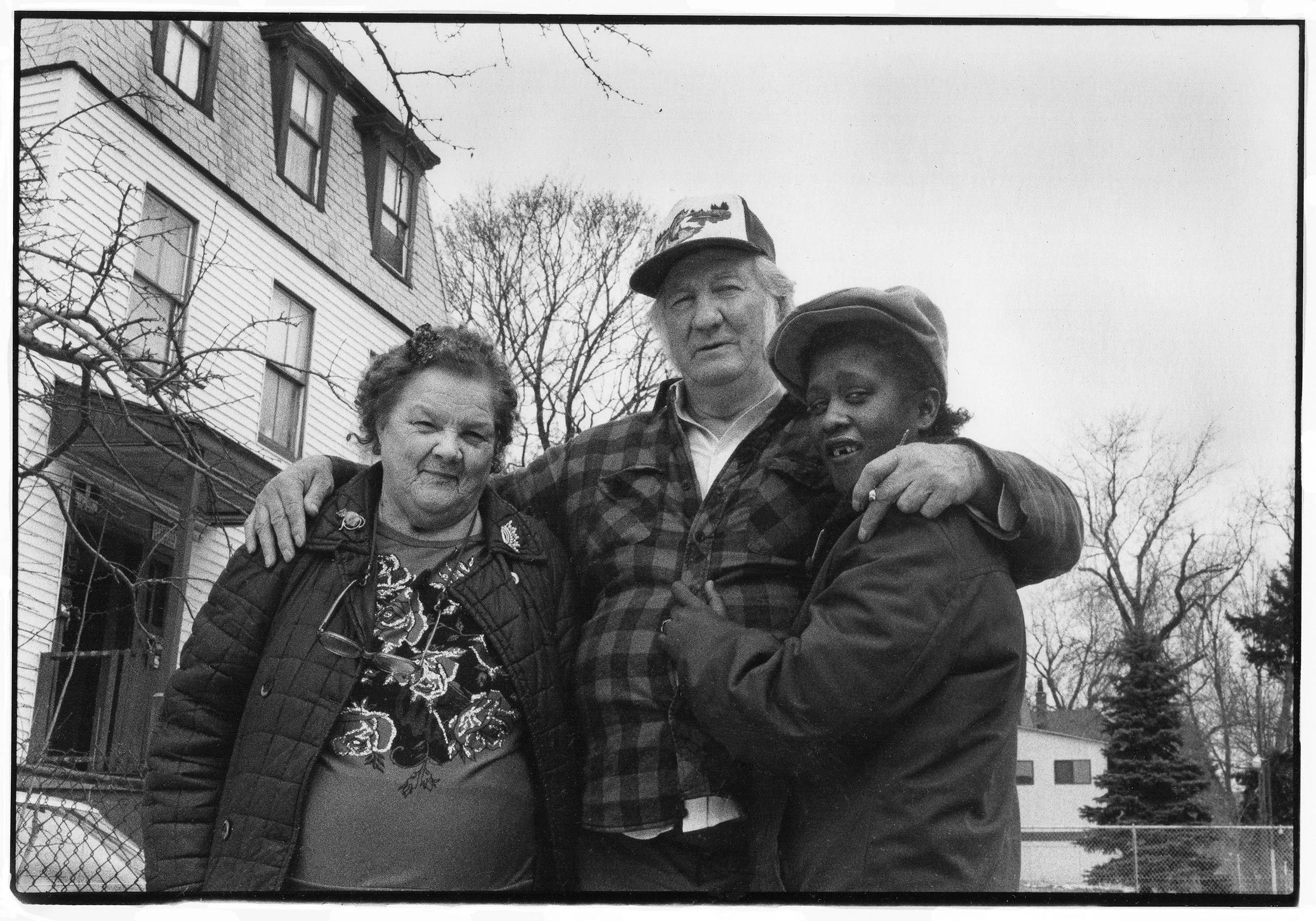 Esther, Mississippi, and Tanya — 
Enveloped in a sea of red-checked wool, Mississippi gives me a great big hug and a kiss on the forehead. I only met him yesterday to take his picture, but he prides himself on knowing everyone. 
Esther says “I was al