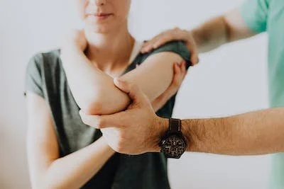 Medical professional administering an injection or vaccine into a woman's upper arm.