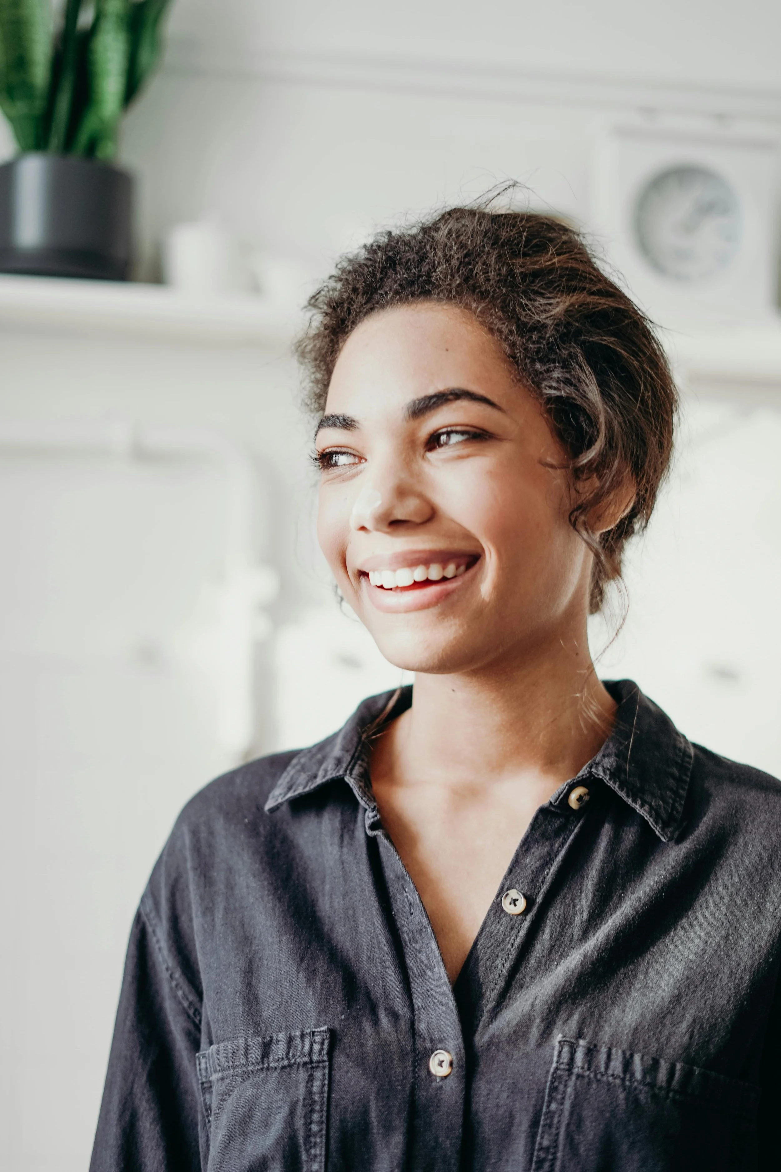 a woman in a black button down smiling