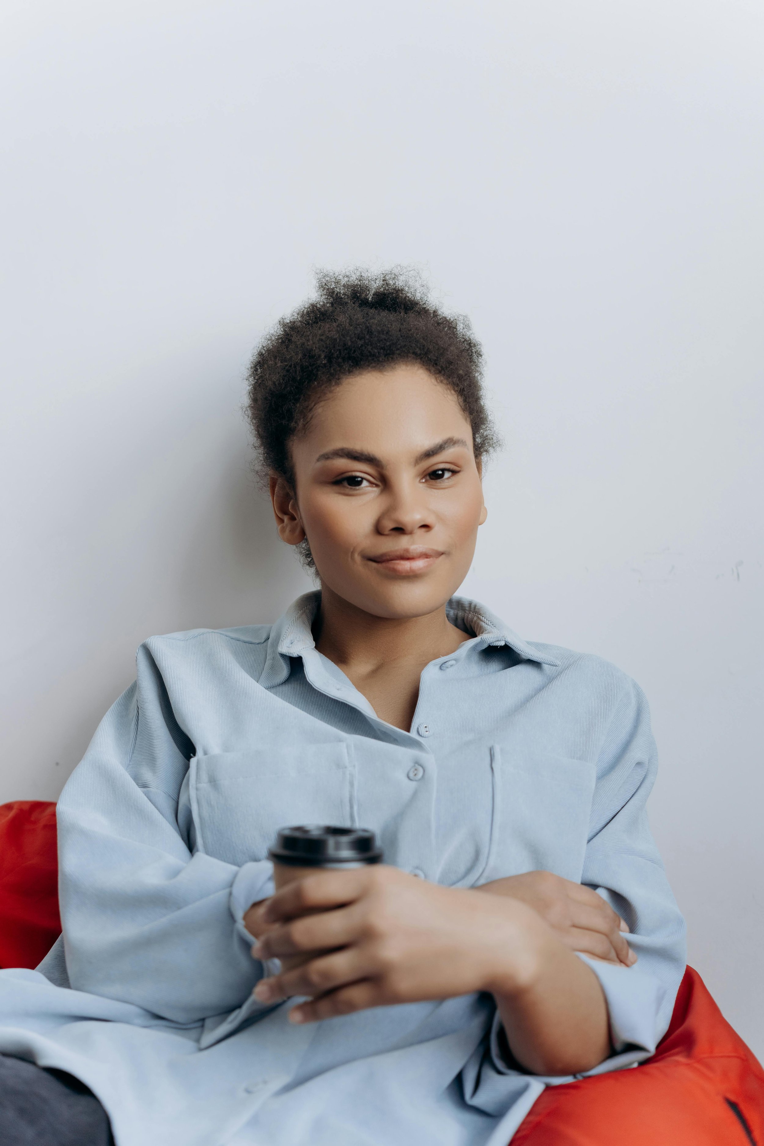 a woman holding a coffee cup and smiling