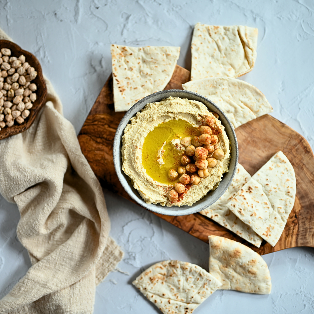 Image of hummus with pita bread.