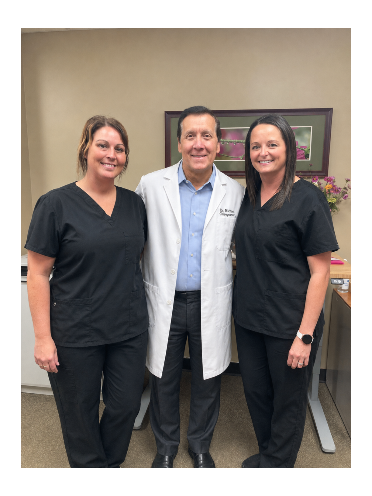 Three healthcare professionals standing together in an office.