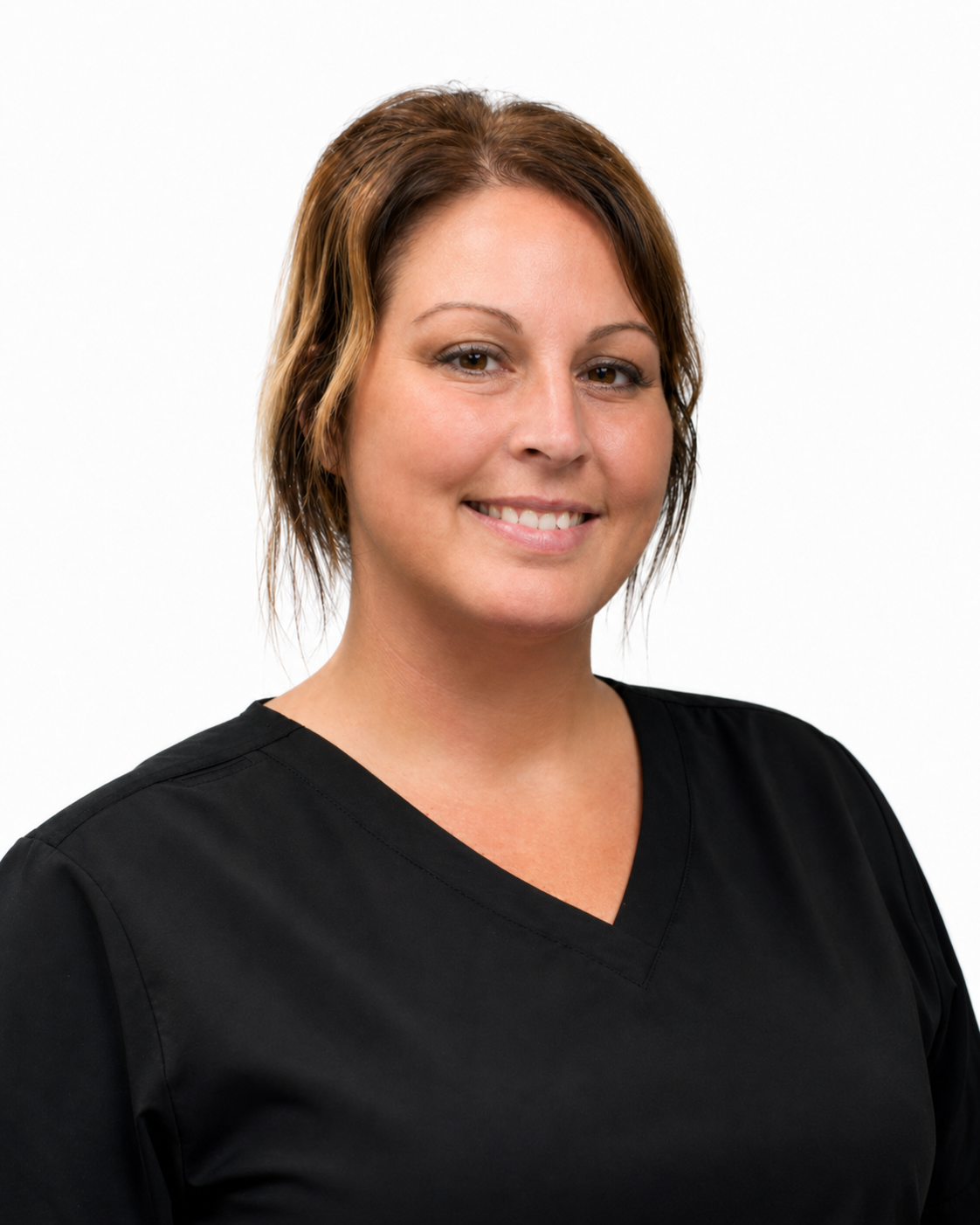 Headshot of a smiling woman with short brown hair wearing a black medical scrub top against a white background.