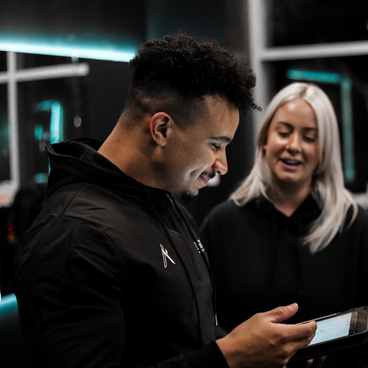 An Inertia coach and client reviewing their personalized training plan