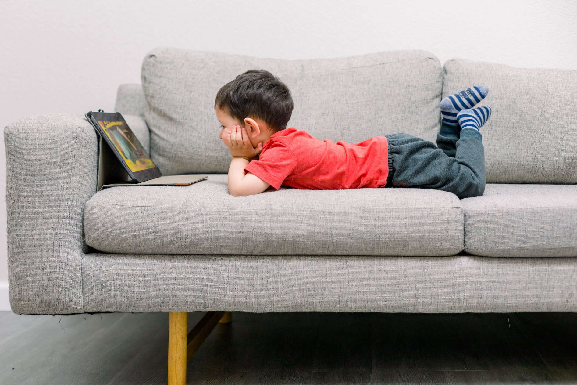 A little boy watches a show on his iPad
