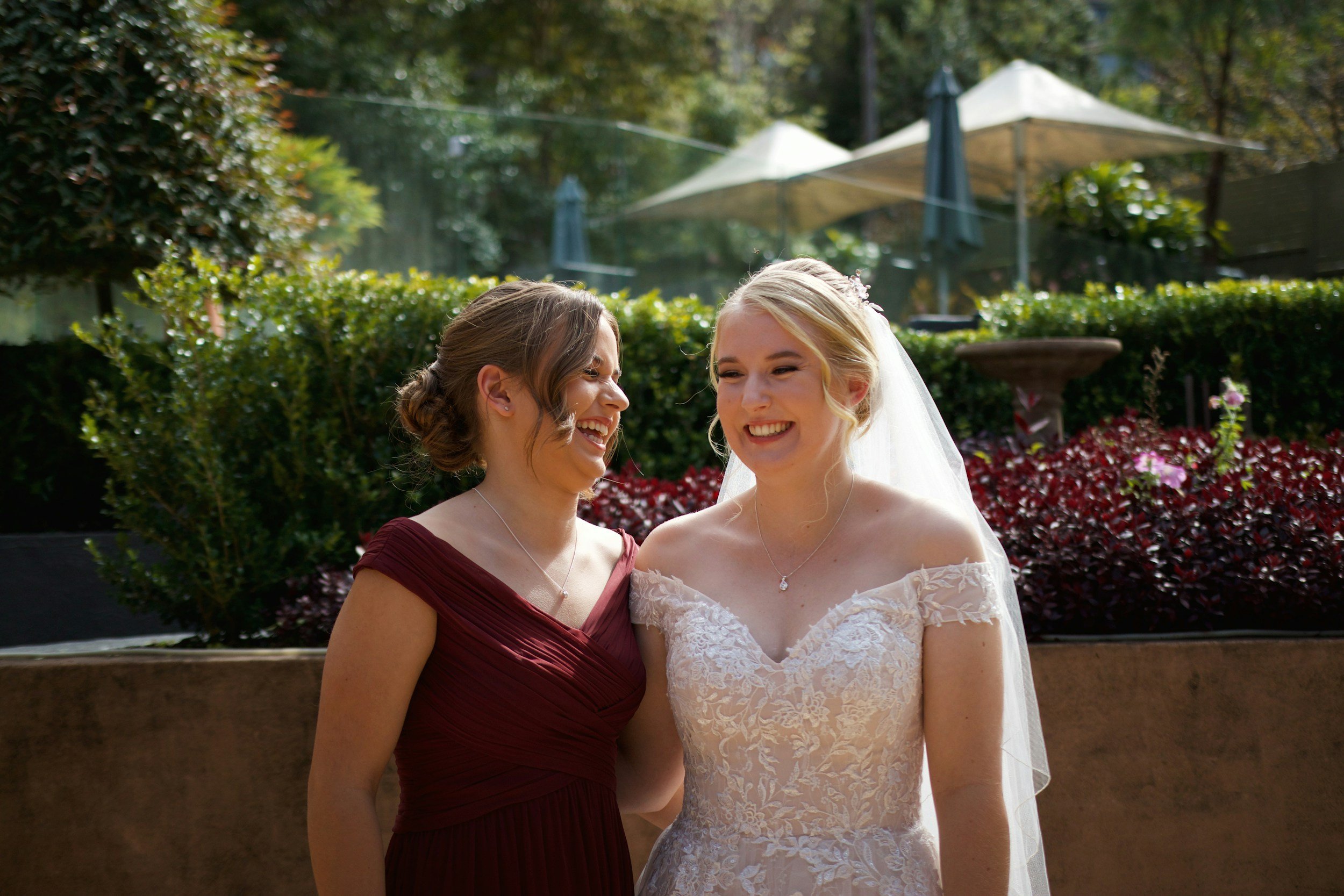 Bride and maid of honor sharing an emotional best friend moment on the wedding day