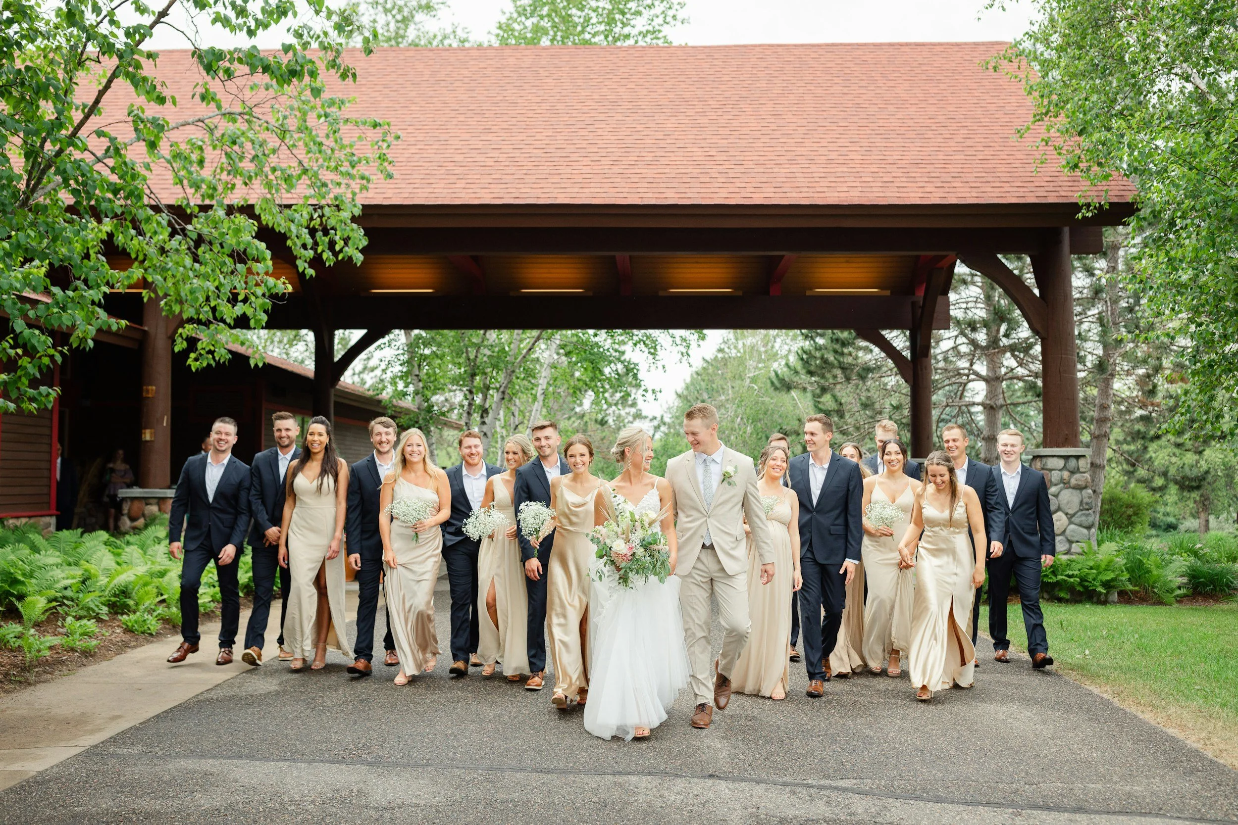Bride and groom smiling with their wedding party.
