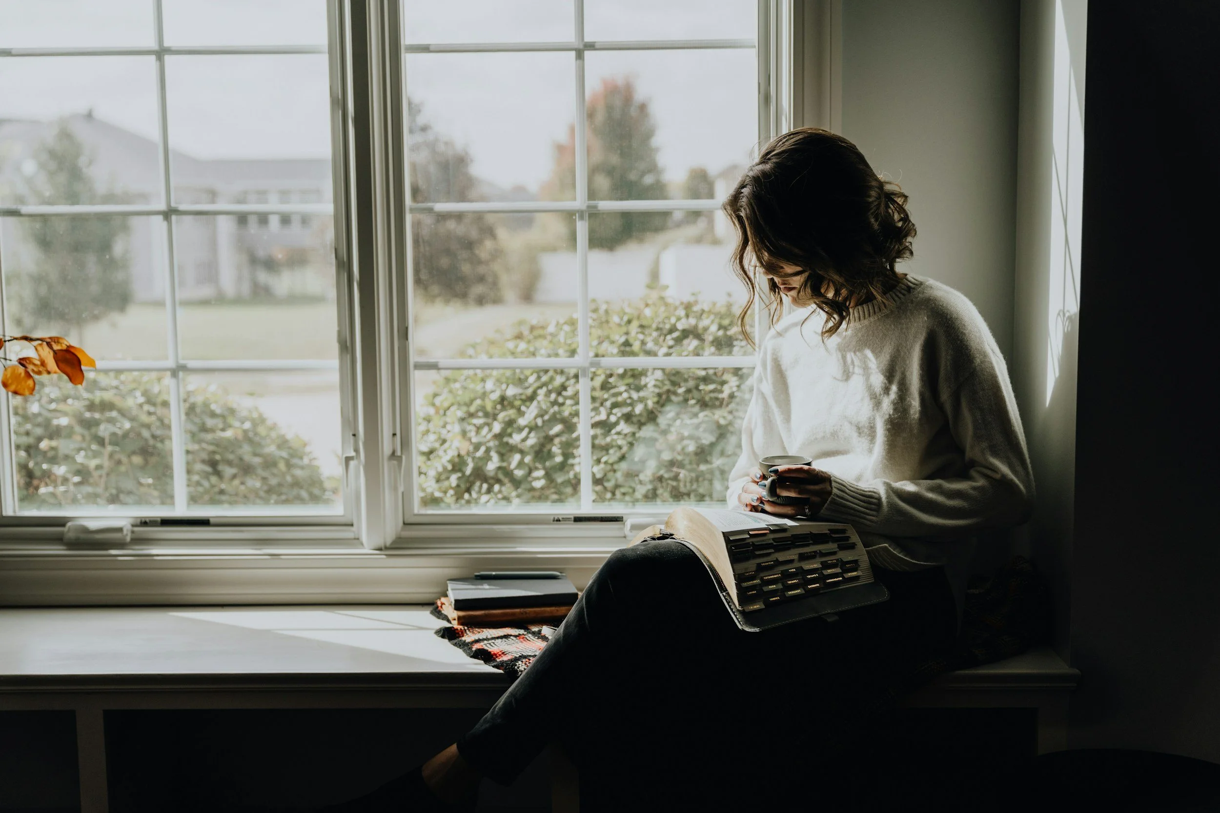 Christian bride writing her wedding vows with Bible by her side.