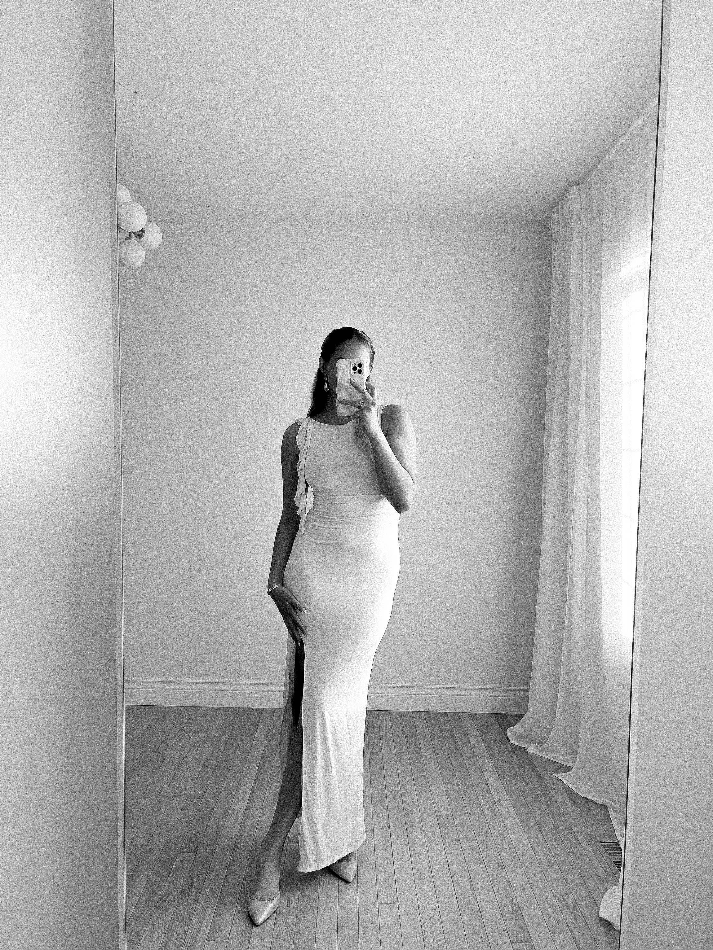 Maid of honor reading wedding speech from her phone during reception