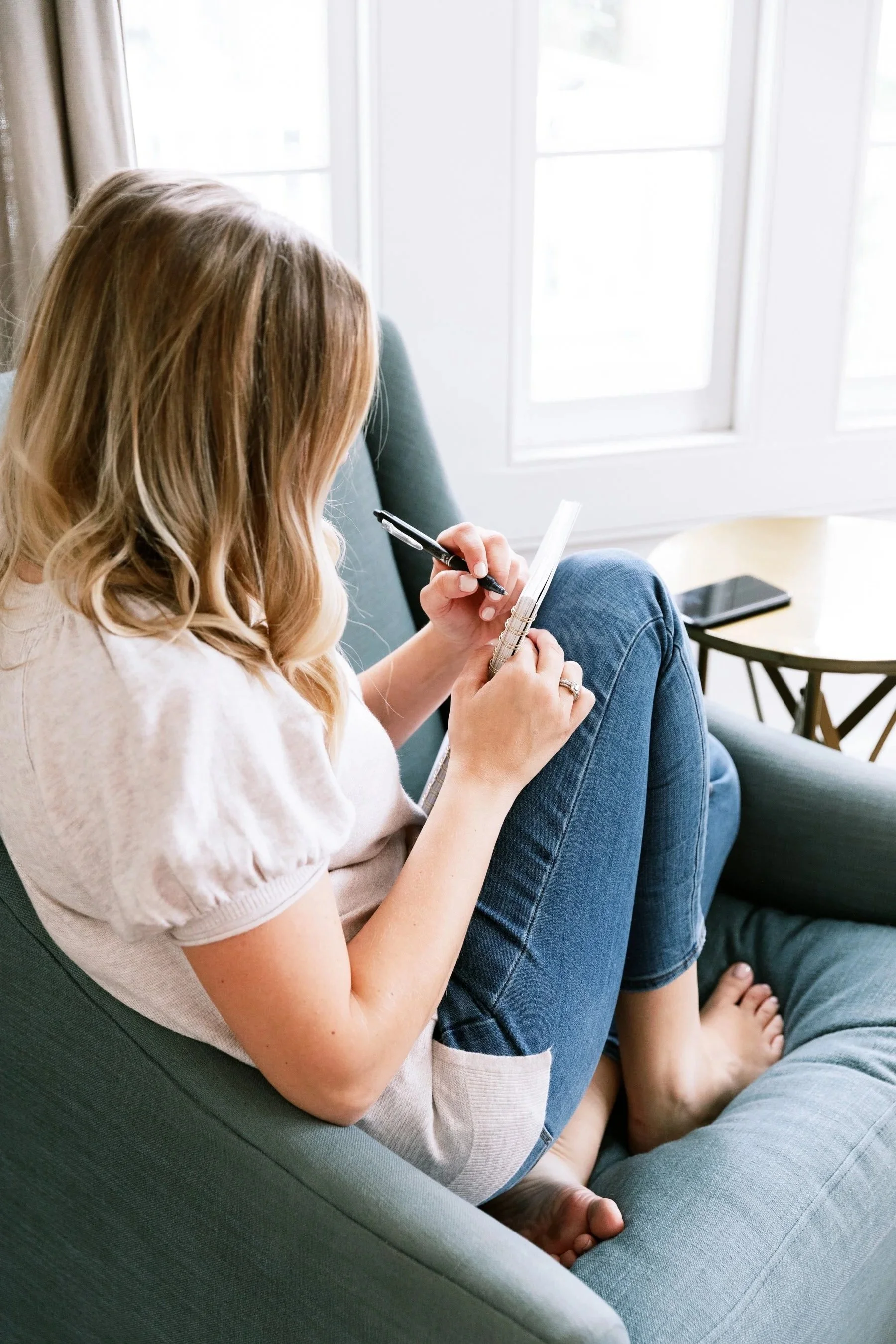 Young woman working with a professional wedding writer to get help with her marriage vows.
