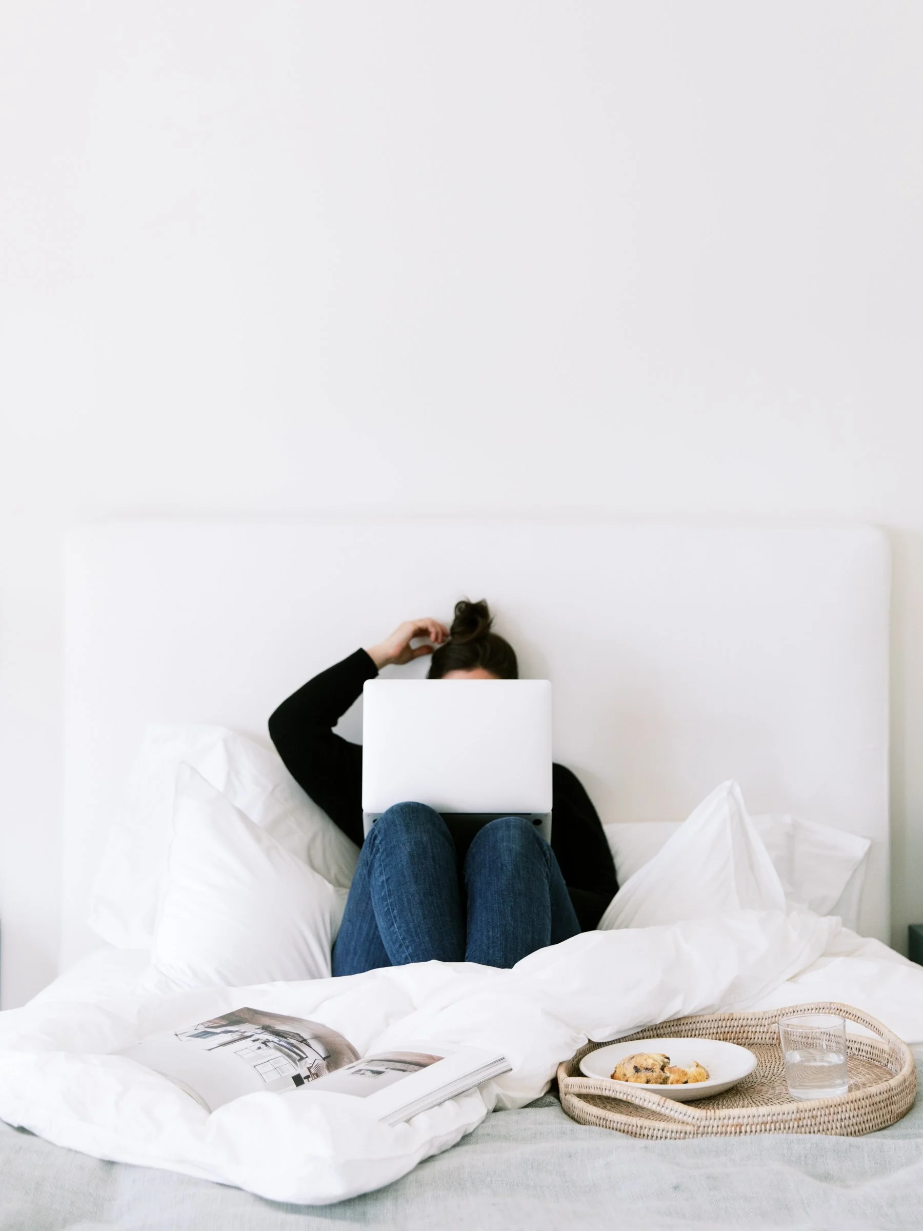 maid of honor writing her wedding speech on a laptop while preparing at home