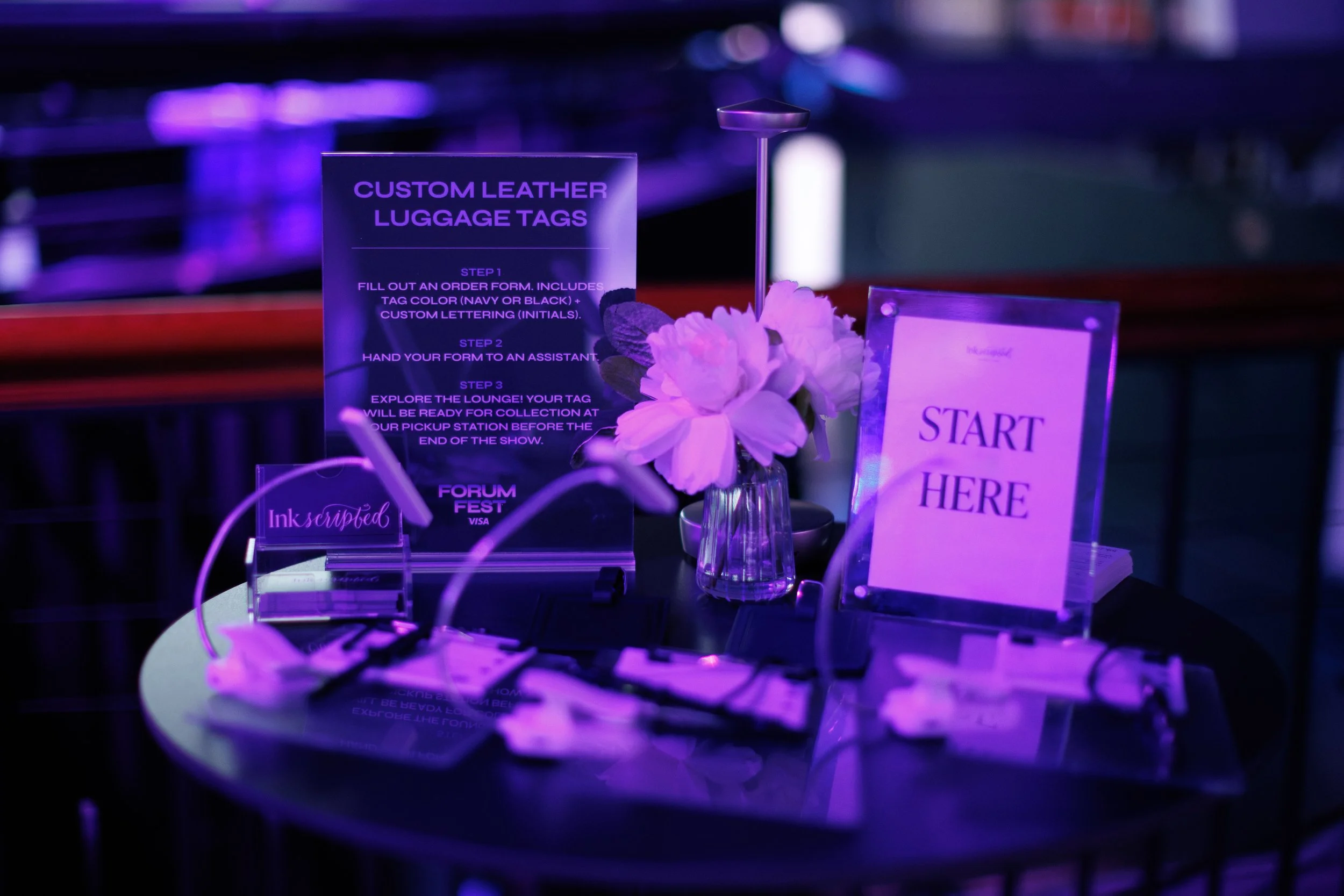genuine-leather-luggage-tags-silver-foiling-customization-hand-calligraphy-personalization-VIP-activation-logo-embossing-visa-forum-fest-table-setup-signage-san-francisco.jpg