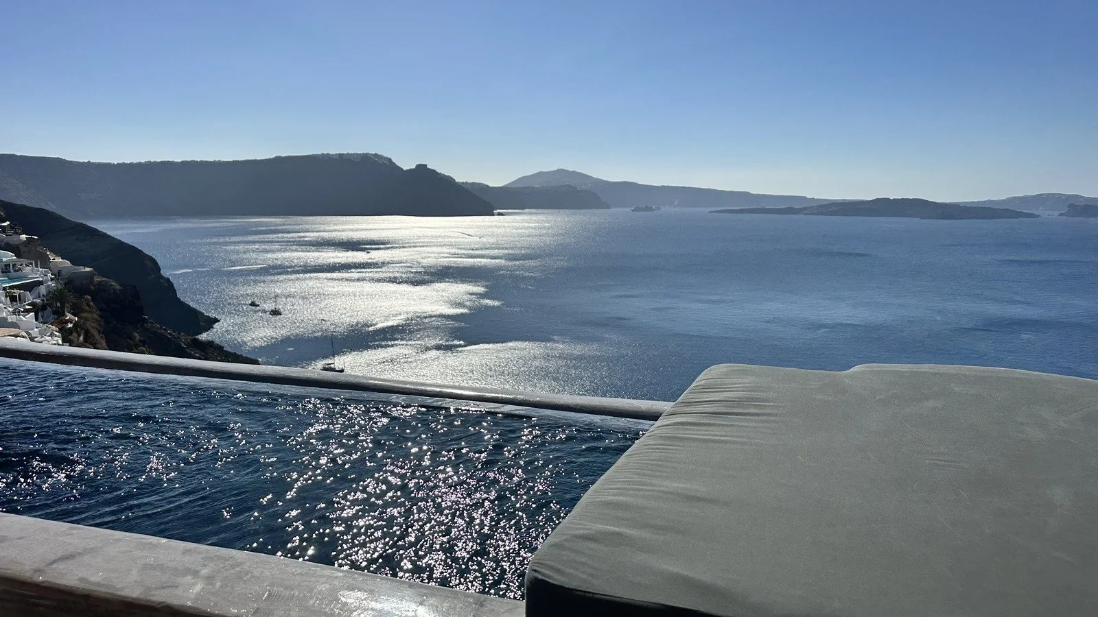Sunset view of the Santorini caldera from a quiet infinity pool