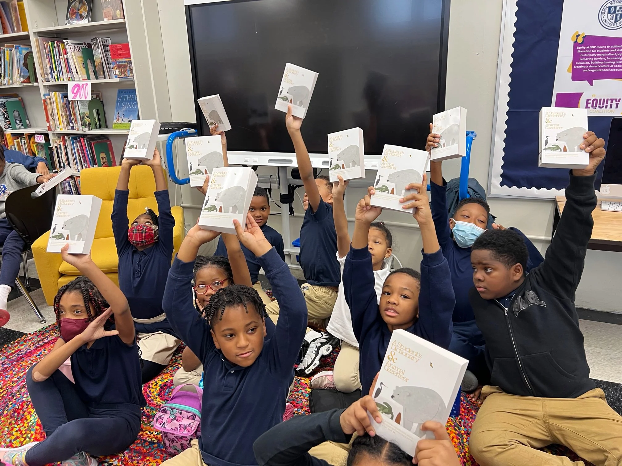 Student receiving dictionaries donated by the Rotary Club of Chestnut Hill