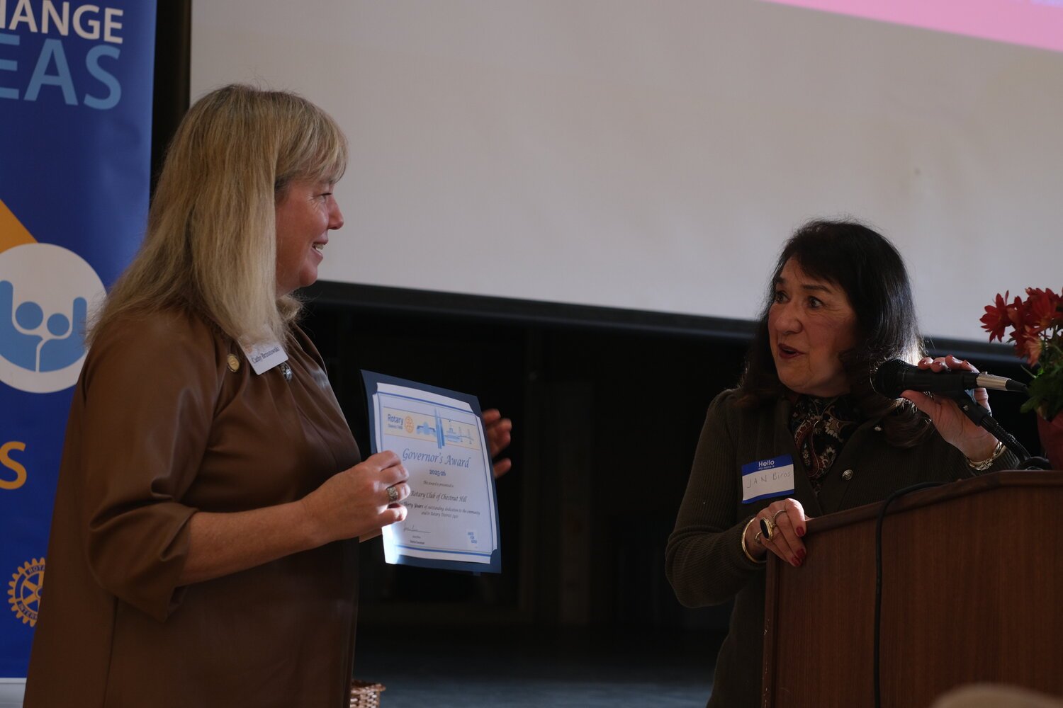   Cathy Brzozowski (left), president of the Rotary Club of Chestnut Hill, receives a certificate for the club’s 30 years of service from Jan Biros, governor of Rotary District 7450. Photo by Tommy Tucker.  