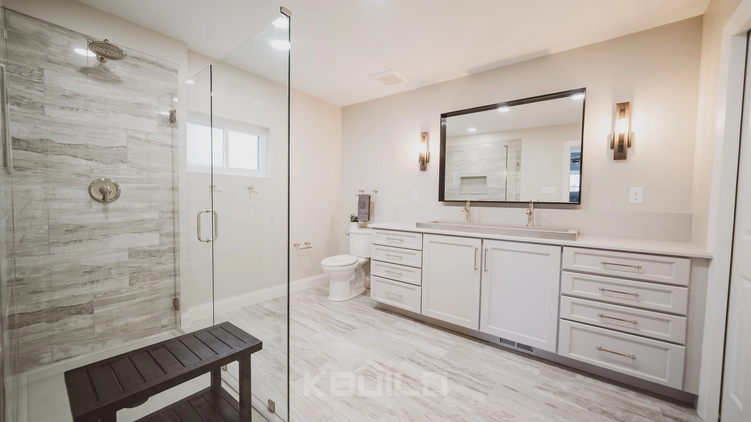 Master bathroom with white vanity and double sink and shower stall