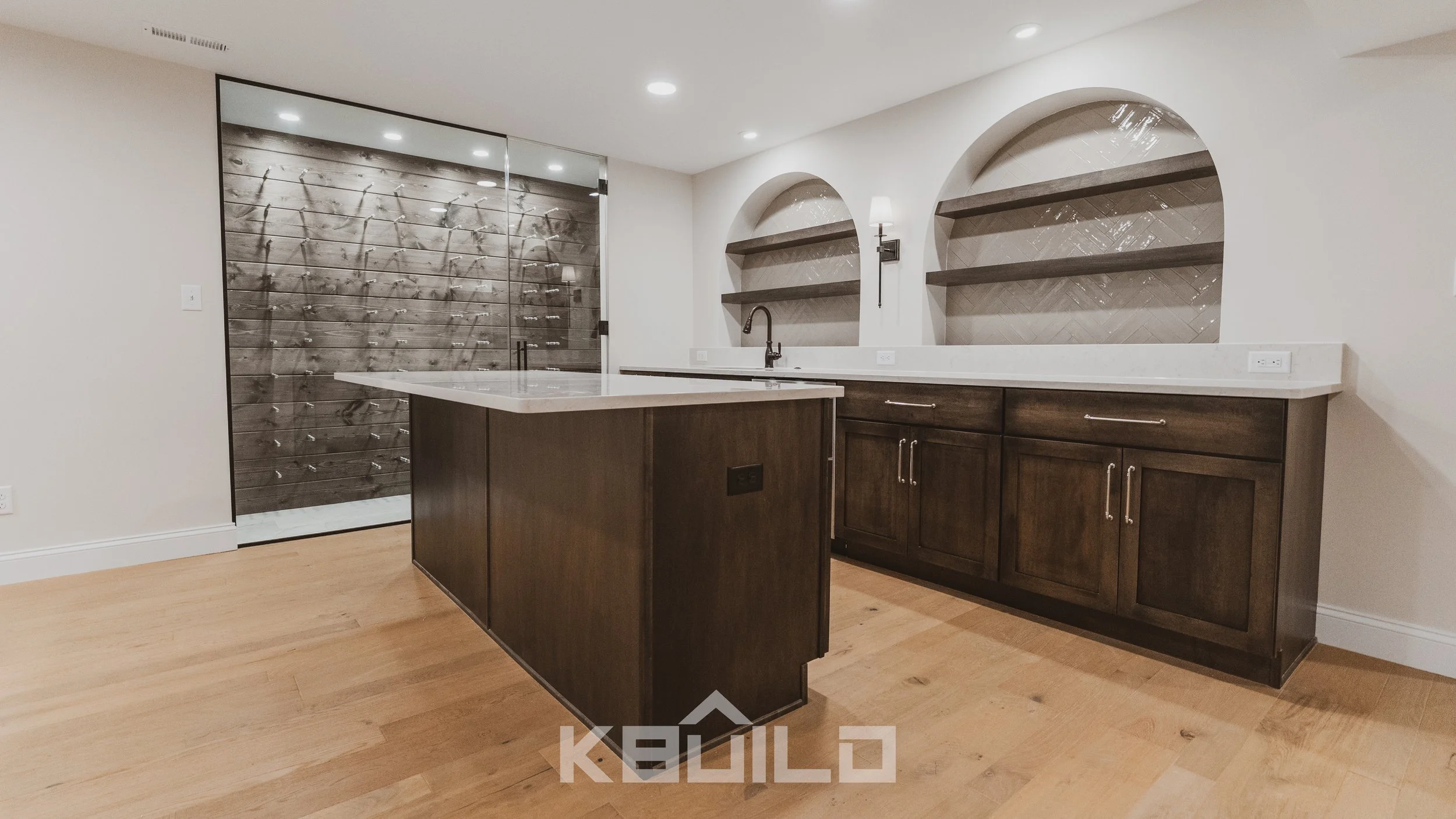 Custom home bar with dark wood cabinets, quartz countertops, open shelving, and glass wine cellar ideal for luxury basement remodels