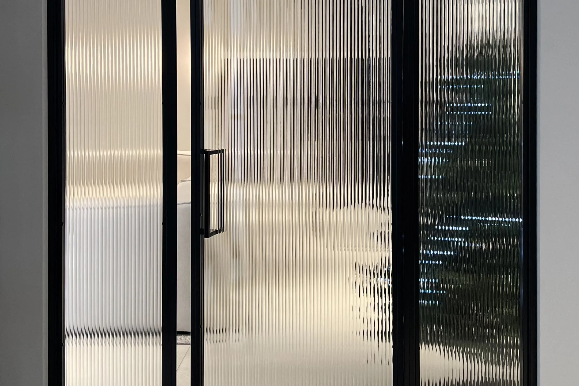 Reeded glass diffusing warm Christmas lighting with festive decor